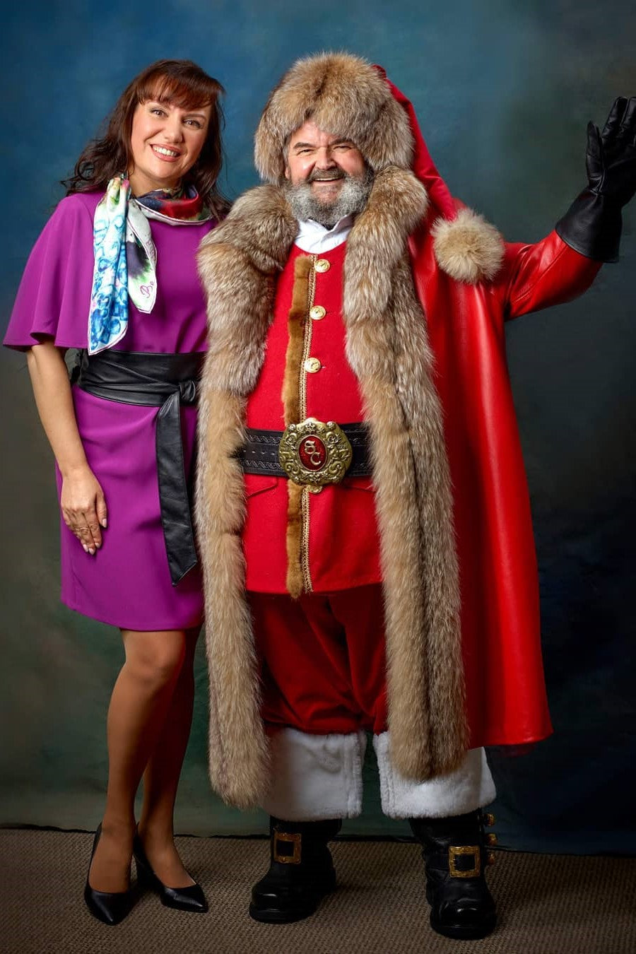 Fashion designer Alesia Chaika with a client Wearing Custom Sanata costume in Red Lamb Genuine Leather Coat with Fox Fur Trim, Hat, Pant, Vest, White Shirt, Black Boots an Santa Leather Belt inspired by the Chrismas Chronicles Movie. AlesiaC.com