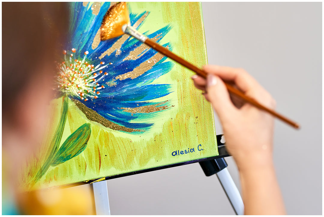 Abstract Cornflower Silk Scarf in Blue and Olive from the Alesia C. Art-A-Porte Collection transforms original fine art into a luxury accessory. The design is reproduced from Alesia Chaika’s acrylic and gold leaf painting, capturing soft blue tones, deep olive, and shimmering gold accents.