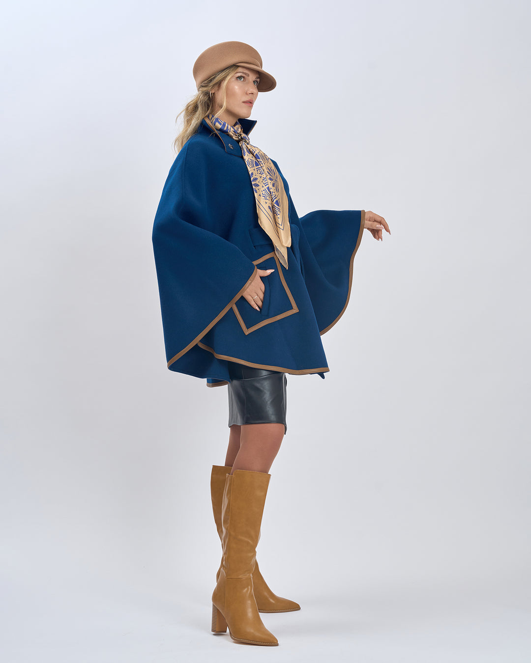 Gold Navy Blue Silk Scarf Styled With Infinity8 Scarf Ring and Paired With Navy Blue Short SWAN Cape-Coat With Brown Leather Trim, Black Felted Wool Visor Beret, Black Leather Skirt and Beige High Boots by Alesia Chaika AlesiaC.com 
